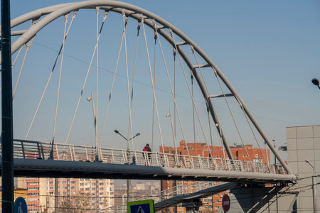 Oval arch of a pedestrian bridge over a road in the city. Pedestrian bridge in the metropolis.の写真素材