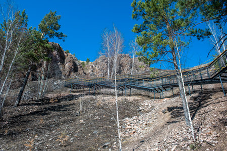 Metal stairs with wooden railings on the mountain. Staircase in the national park.の写真素材