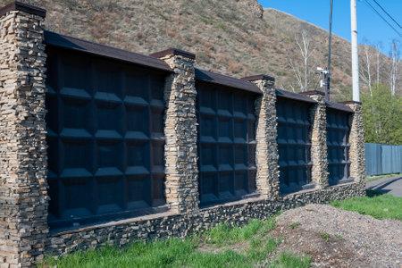 Stone fence with video surveillance system. Protection of private territories.の写真素材