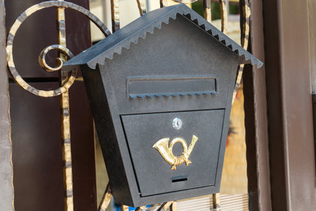 Mailbox for paper letters on the fence. Letter box on the street.