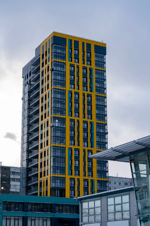 Facade of a high rise residential building against a cloudy sky. High rise residential building with balconies.の写真素材