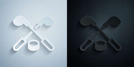 Paper cut Ice hockey sticks and puck icon isolated on grey and black background. Game start. Paper art style. Vectorのイラスト素材