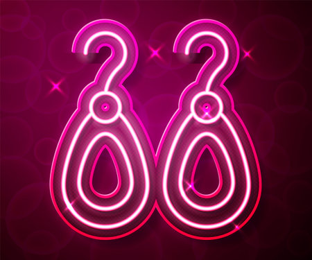 Glowing neon line Earrings icon isolated on red background. Jewelry accessories. Vectorのイラスト素材