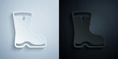 Paper cut Fishing boots icon isolated on grey and black background. Waterproof rubber boot. Gumboots for rainy weather, fishing, hunter, gardening. Paper art style. Vectorのイラスト素材