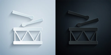 Paper cut Drum with drum sticks icon isolated on grey and black background. Music sign. Musical instrument symbol. Paper art style. Vectorのイラスト素材