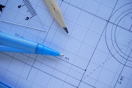 Close-up of Architect engineer drawing plan on blueprint with architect equipment. Architect Desk...