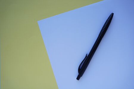 white paper and pen on wooden vintage background. Office Minimalism Concept. Flat lay copy space for advertising and textの写真素材