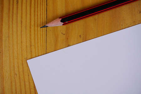 blank paper sheets and pencil on wooden table. vintage copy space background conceptの写真素材