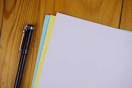blank paper sheets and pen on wooden table. vintage background concept