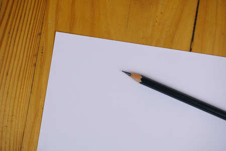 blank paper sheets and pencil on wooden table. vintage copy space background conceptの写真素材