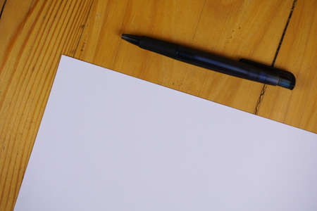 blank paper sheets and pen on wooden table. vintage background conceptの写真素材