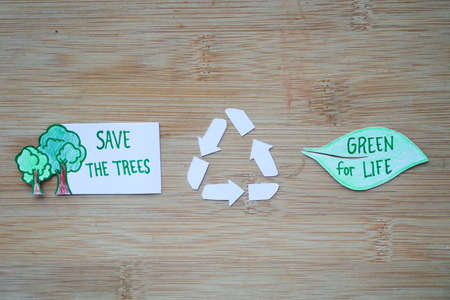 Phrase of Earth day. Saving our earth, go green, recycle symbol concept background on wooden boardの写真素材