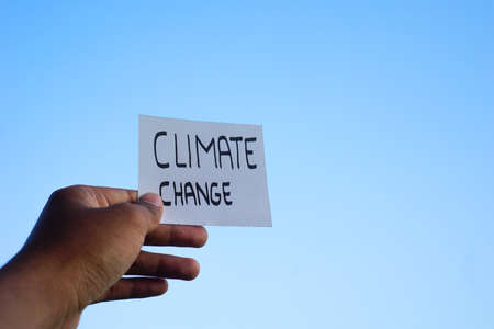 hand holding Climate change Text concept with rock background. Ready Text for environment earth day...