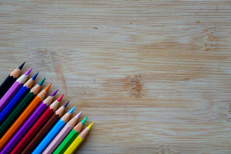 Arrange of pencils color and some origami paper with rustic wooden background. Back to school conceptの写真素材