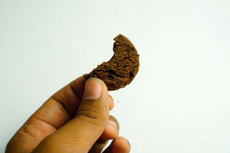 chocolate cookies and dark chocolate grain on wooden board background. for text concept advertising