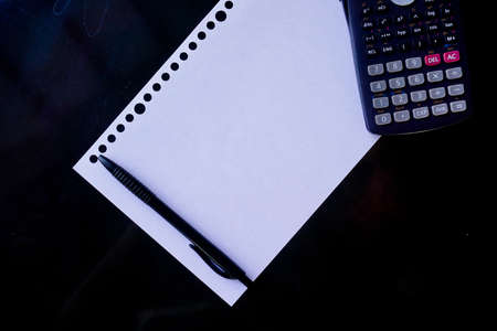 blank paper, ballpoint, and calculator for mockup concept on wooden board. finance, education backgroundの写真素材