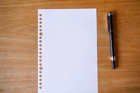 blank paper, ballpoint, and calculator for mockup concept on wooden board. finance, education backgroundの写真素材