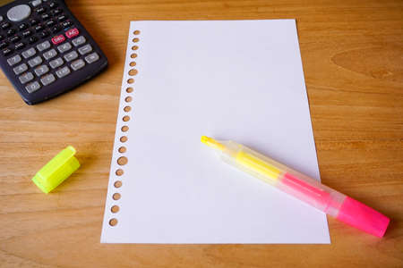 blank paper, ballpoint, and calculator for mockup concept on wooden board. finance, education backgroundの写真素材