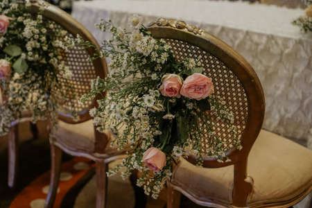 Flower bouquet focus hanging on chair Declaration and promise wedding ceremony stage decorationの写真素材