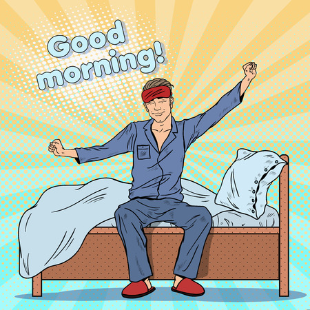 Pop Art Happy Man Stretching on Bed after Waking Up. Vector illustrationのイラスト素材