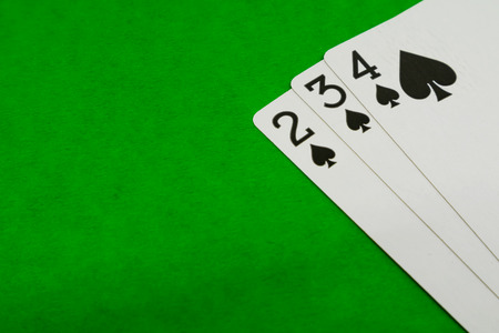 Combination of playing or poker cards on green background.の写真素材