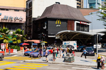 KUALA LUMPUR, MALAYSIA - FEBRUARY 11, 2018 : People cross the street in front of McDonalds restaurant at Pudu street near Kota Raya Shopping Complex, One of Kuala Lumpurâs oldest malls.のeditorial素材