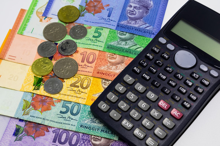Malaysia Ringgit banknotes with calculator and coins in white background. Financial and Business concept.の写真素材