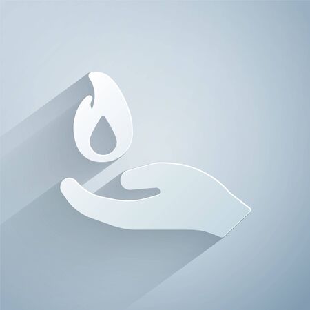 Paper cut Hand holding a fire icon isolated on grey background. Paper art style.のイラスト素材