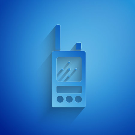 Paper cut Walkie talkie icon isolated on blue background. Portable radio transmitter icon. Radio transceiver sign. Paper art style. Vectorのイラスト素材