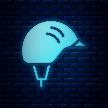 Glowing neon Bicycle helmet icon isolated on brick wall background. Extreme sport. Sport equipment. Vectorのイラスト素材