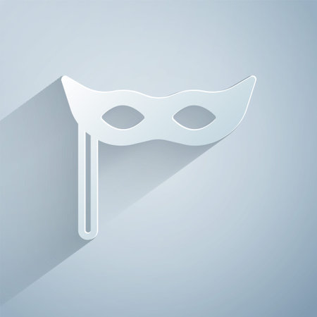 Paper cut Festive mask icon isolated on grey background. Merry Christmas and Happy New Year. Paper art style. Vectorのイラスト素材