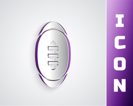 Paper cut American Football ball icon isolated on grey background. Rugby ball icon. Team sport game symbol. Paper art style. Vectorのイラスト素材