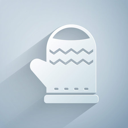 Paper cut Christmas mitten icon isolated on grey background. Merry Christmas and Happy New Year. Paper art style. Vectorのイラスト素材