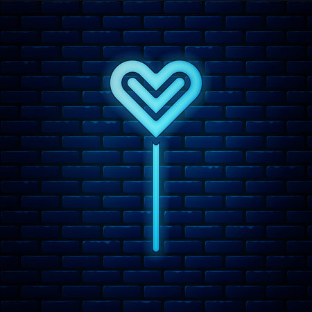 Glowing neon Lollipop icon isolated on brick wall background. Food, delicious symbol. Vectorのイラスト素材