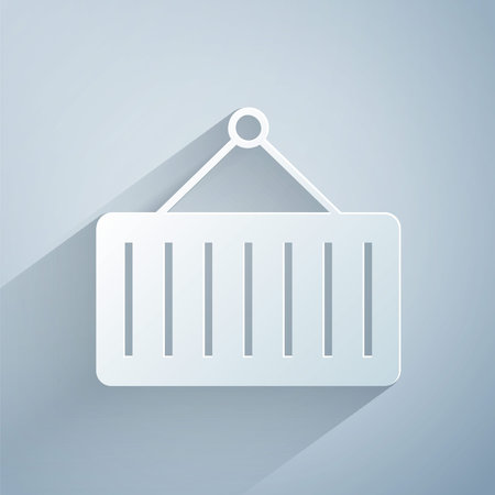 Paper cut Container on crane icon isolated on grey background. Crane lifts a container with cargo....