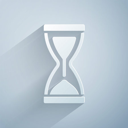 Paper cut Old hourglass with flowing sand icon isolated on grey background. Sand clock sign....