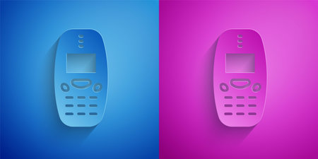 Paper cut Old vintage keypad mobile phone icon isolated on blue and purple background. Retro cellphone device. Vintage 90s mobile phone. Paper art style. Vectorのイラスト素材