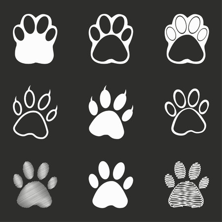 Paw vector icons set. White illustration isolated on black background for graphic and web design.のイラスト素材