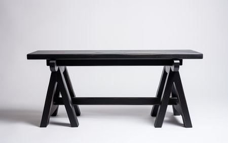 A black trestle bench on a white background.の素材