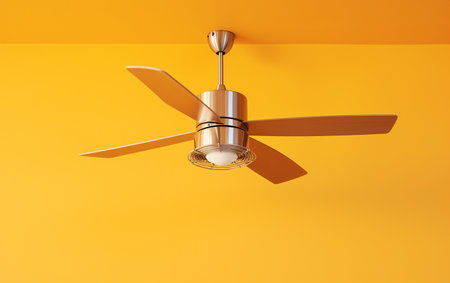 An illuminated ceiling fan set against a yellow backdrop.の素材