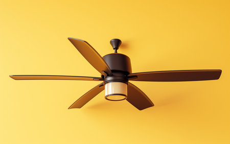 An overhead fan with lighting against a yellow backdrop.の素材