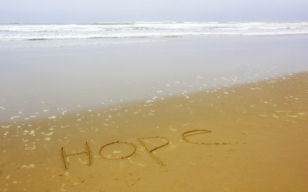 hope writing on beachの写真素材