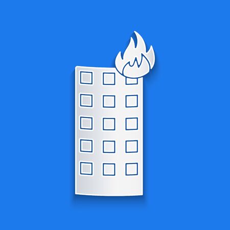 Paper cut Fire in burning building on city street icon isolated on blue background. Paper art style. Vector Illustrationのイラスト素材