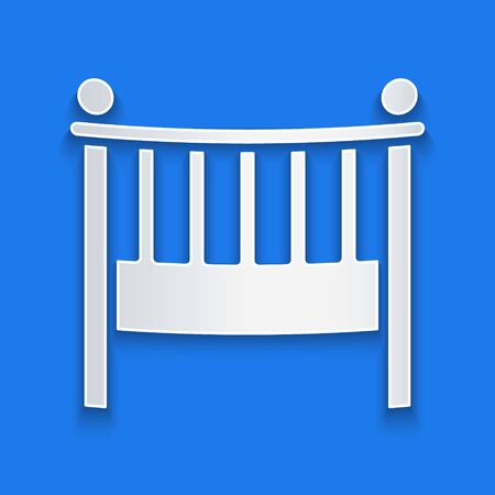 Paper cut Baby crib cradle bed icon isolated on blue background. Paper art style. Vector Illustrationのイラスト素材