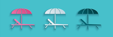 Paper cut Sunbed icon isolated on blue background. Beach umbrella and Sun lounger. Paper art style....