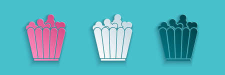 Paper cut Popcorn in cardboard box icon isolated on blue background. Popcorn bucket box. Paper art style. Vector Illustrationのイラスト素材