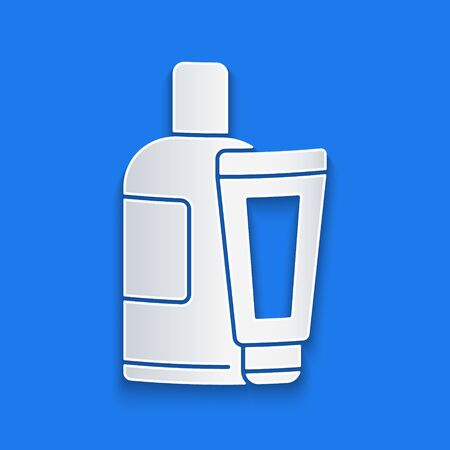 Paper cut Cream or lotion cosmetic tube icon isolated on blue background. Body care products for men. Paper art style. Vector Illustrationのイラスト素材