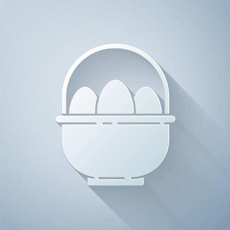 Paper cut Basket with easter eggs icon isolated on grey background. Happy Easter. Paper art style. Vector Illustrationのイラスト素材