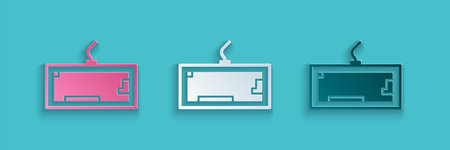 Paper cut Computer keyboard icon isolated on blue background. PC component sign. Paper art style....