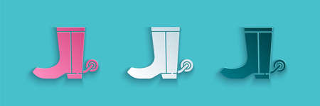 Paper cut Cowboy boot icon isolated on blue background. Paper art style. Vectorのイラスト素材